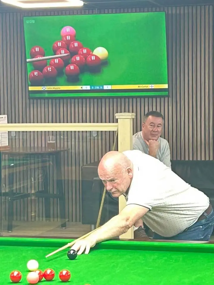 A player down on the black as the World Championship plays on a screen above